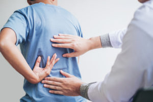 Doctor consulting with patient Back problems Physical therapy