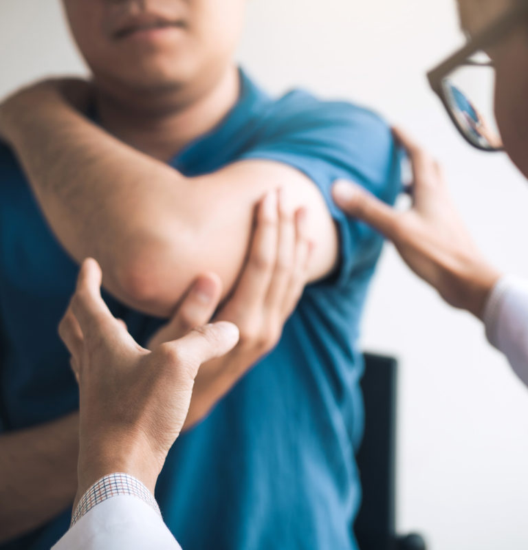 Physical therapists are checking patients elbows at the clinic office room.