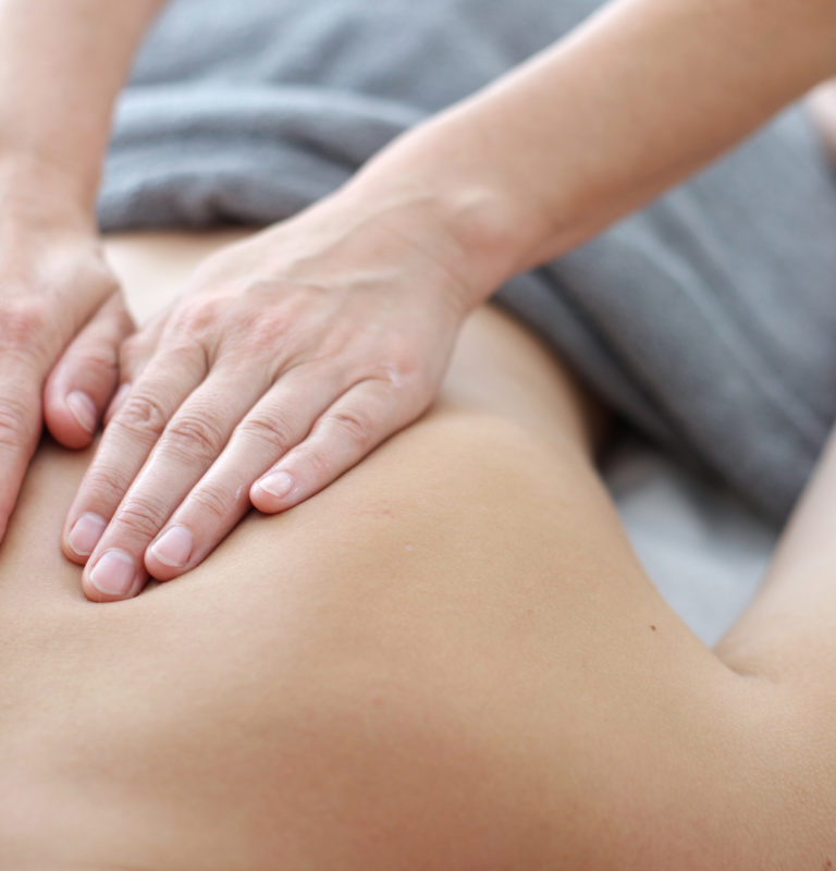Close up of back massage procedure in spa salon