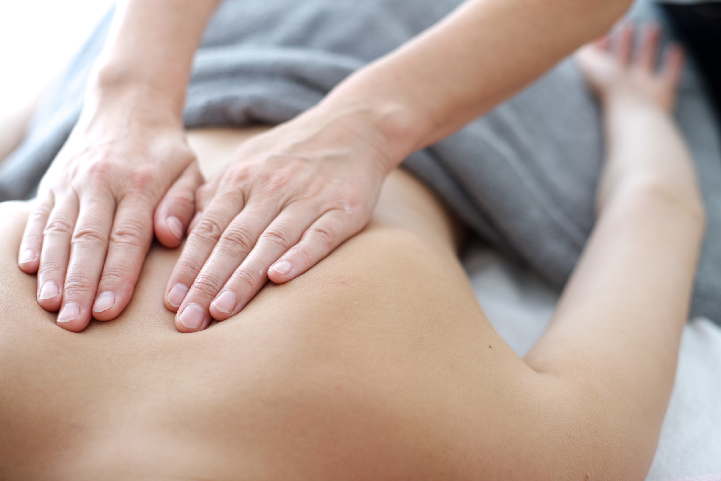 Close up of back massage procedure in spa salon