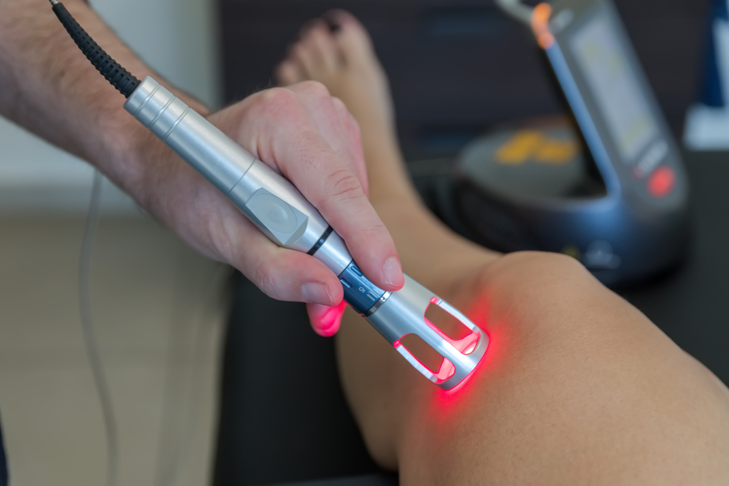 Laser therapy on a knee used to treat pain