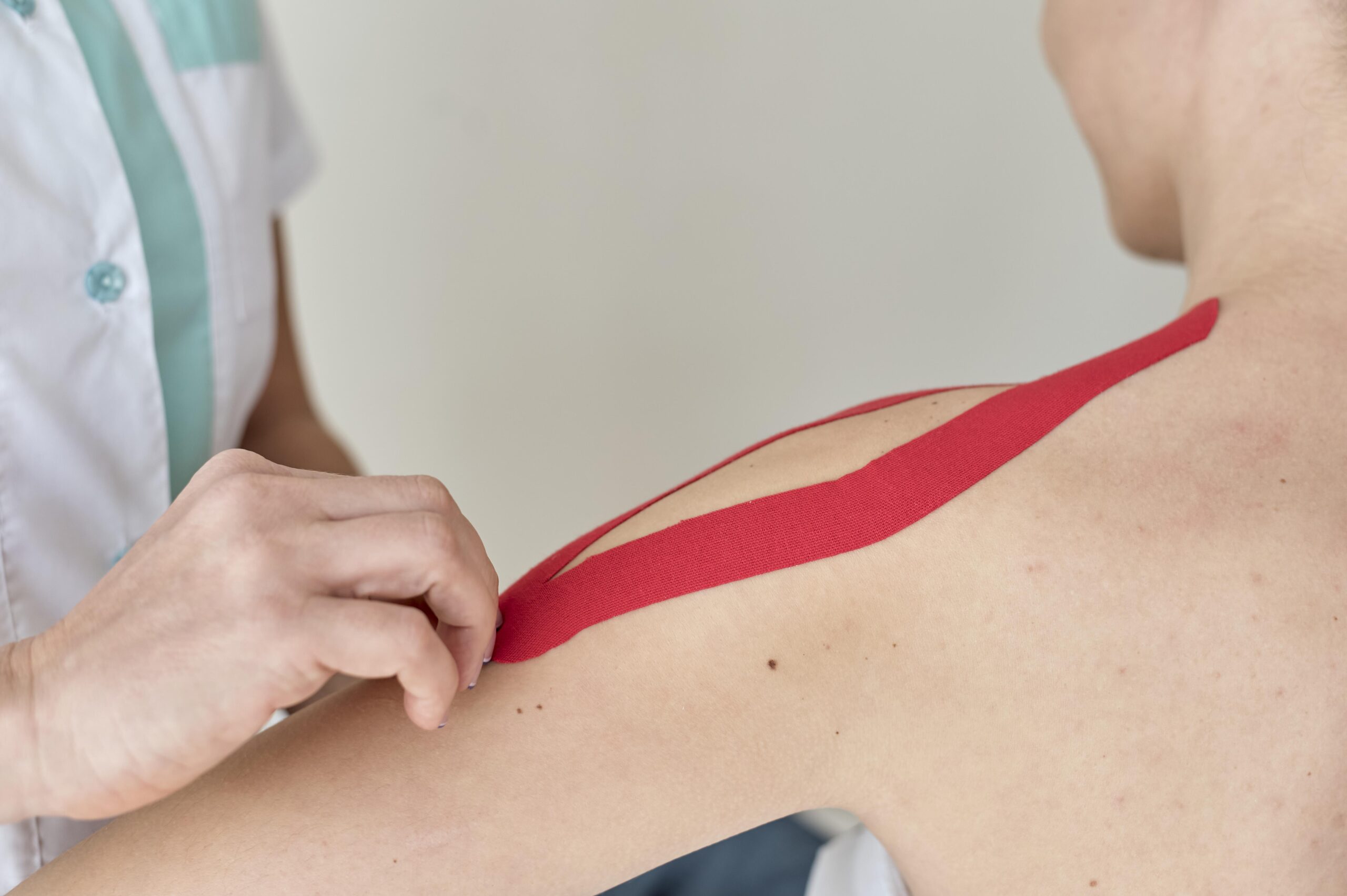 physiotherapist-undergoing-therapy-with-female-patient